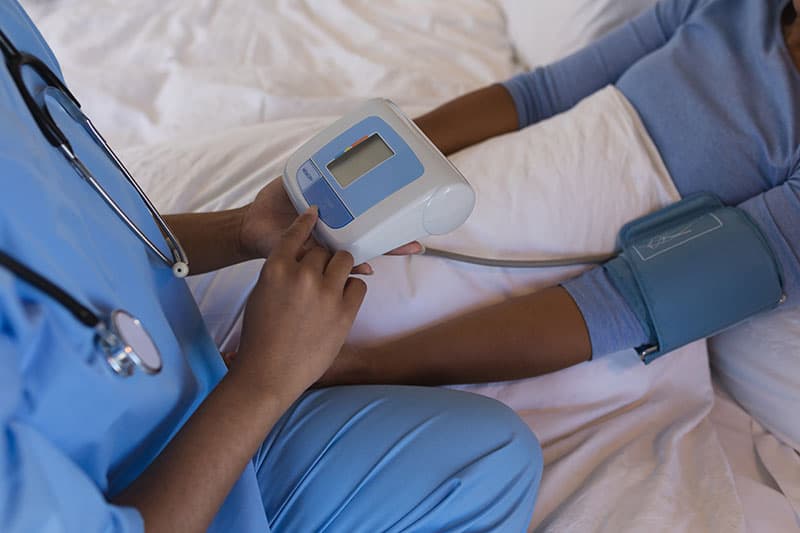 young-female-doctor-measuring-blood-pressure-of-patient